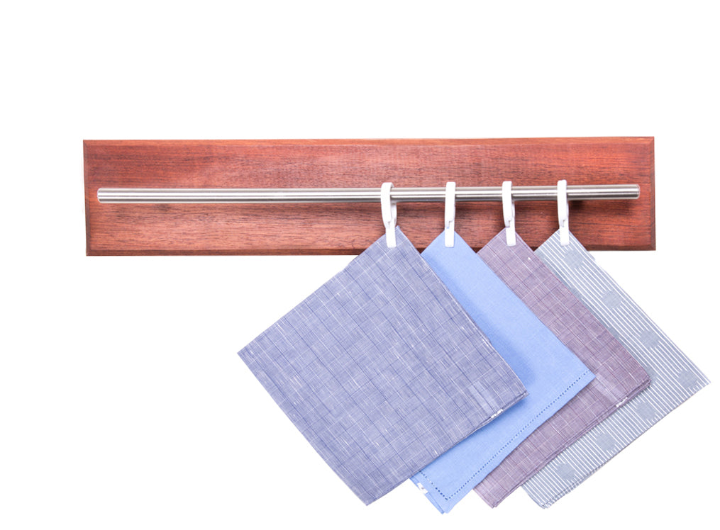 Four towels hanging on a KirbyAllison.com Custom Hanger Project M Size Tie & Pocket Square Rod wooden rack.
