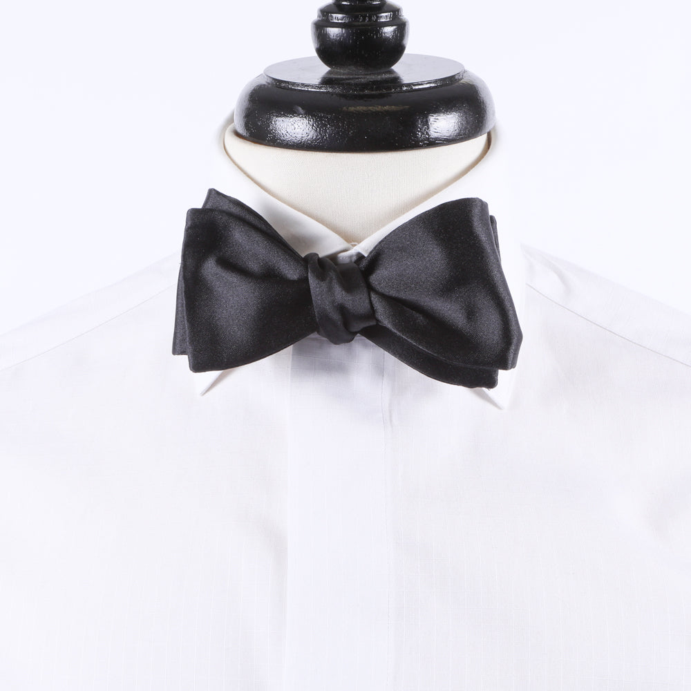 A Sovereign Grade Black Satin Bow Tie from KirbyAllison.com on a mannequin for formal black tie events.