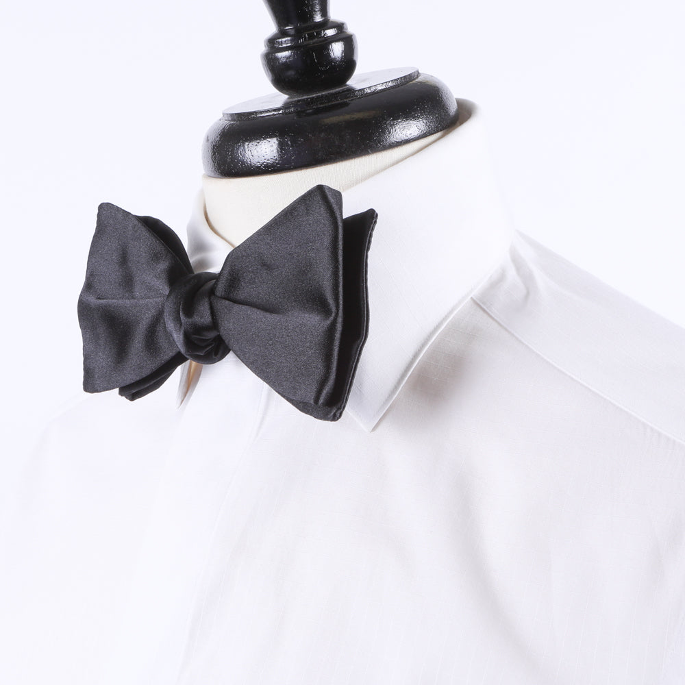 An adjustable slider Sovereign Grade Jumbo Satin Butterfly Bow Tie on a white shirt mannequin for formal black tie events from KirbyAllison.com.