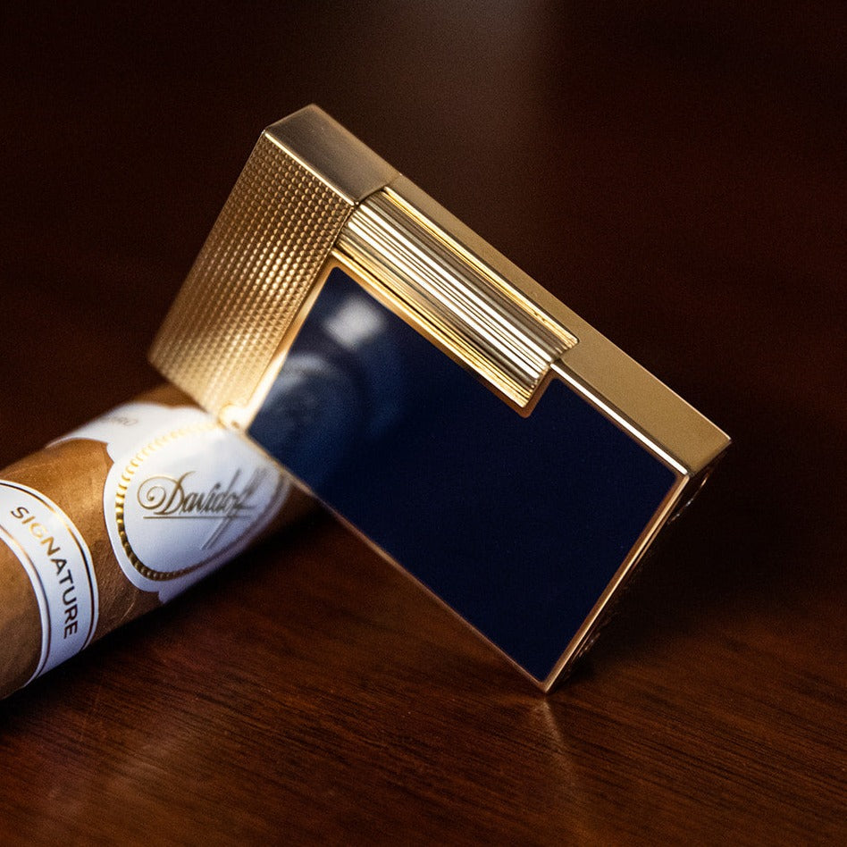 S.T. Dupont Line 2 Gold Blue Lacquer Lighter featuring a platinum micro-diamond head pattern and a distinct ping sound.