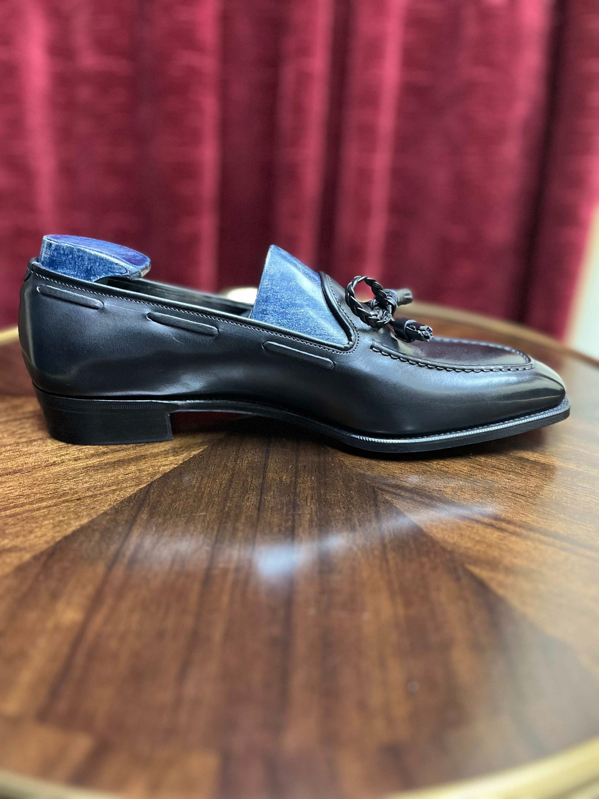 A Anthony Cleverley Baron de Rede Black Casual Loafer, UK 9.0 Wide on a table from KirbyAllison.com.