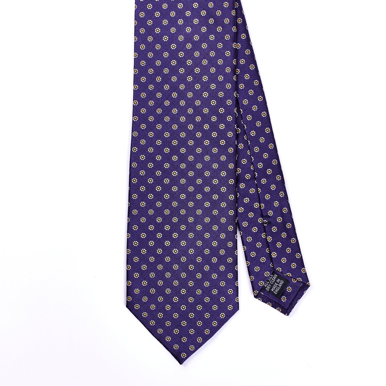 A handmade purple and gold polka dot Sovereign Grade Plum Floral Jacquard tie on a white background, inspired by KirbyAllison.com.