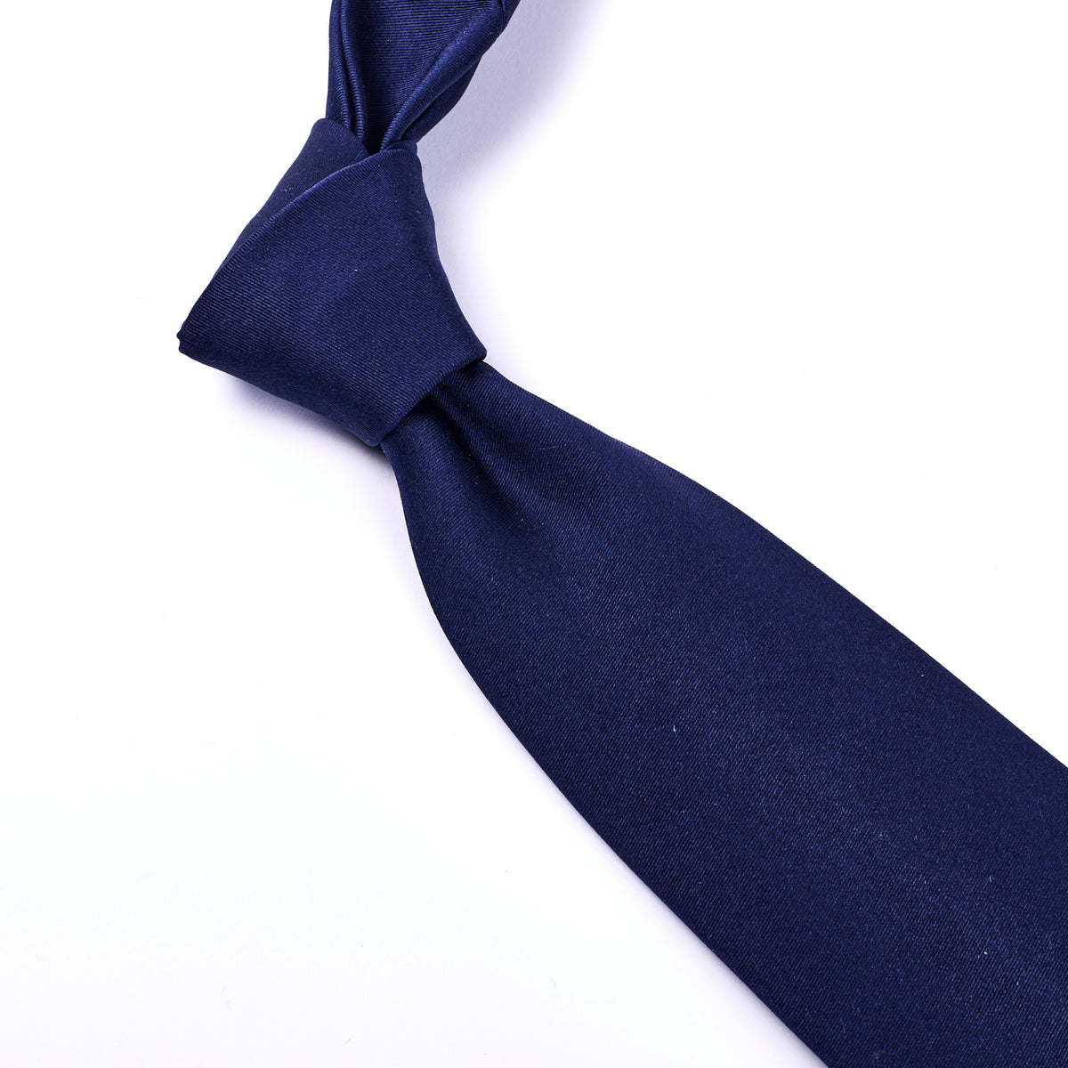 A handmade Sovereign Grade Midnight Blue Satin Tie from KirbyAllison.com on a white background.