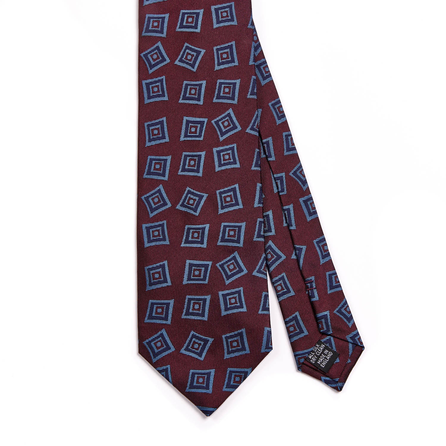 A Sovereign Grade Oxblood Art Deco Jacquard Tie, 150 cm with blue squares on it, crafted with quality in the United Kingdom, by KirbyAllison.com.