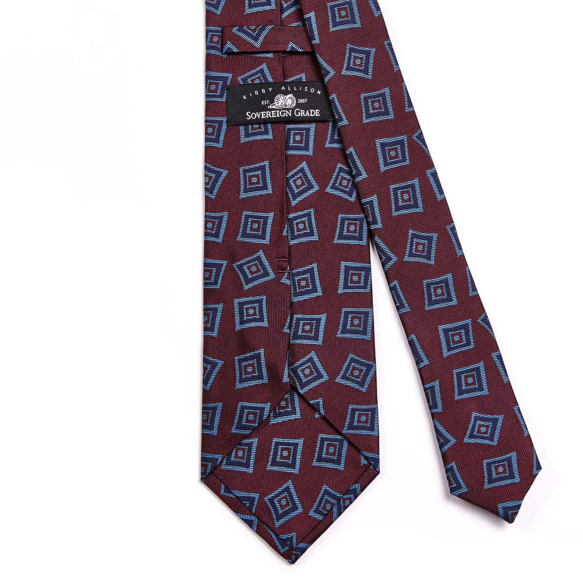 A Sovereign Grade Oxblood Art Deco Jacquard Tie, 150 cm from KirbyAllison.com with blue and red designs showcasing quality craftsmanship.