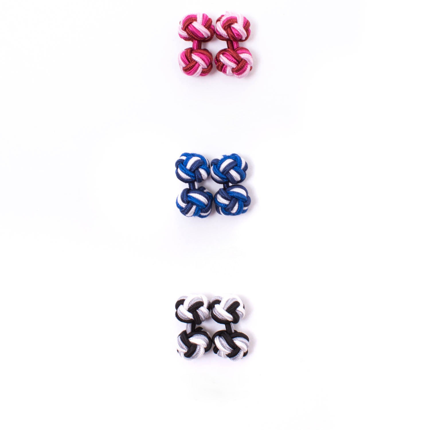 Four Tri-Colored Knot Cufflinks by KirbyAllison.com on a white surface.