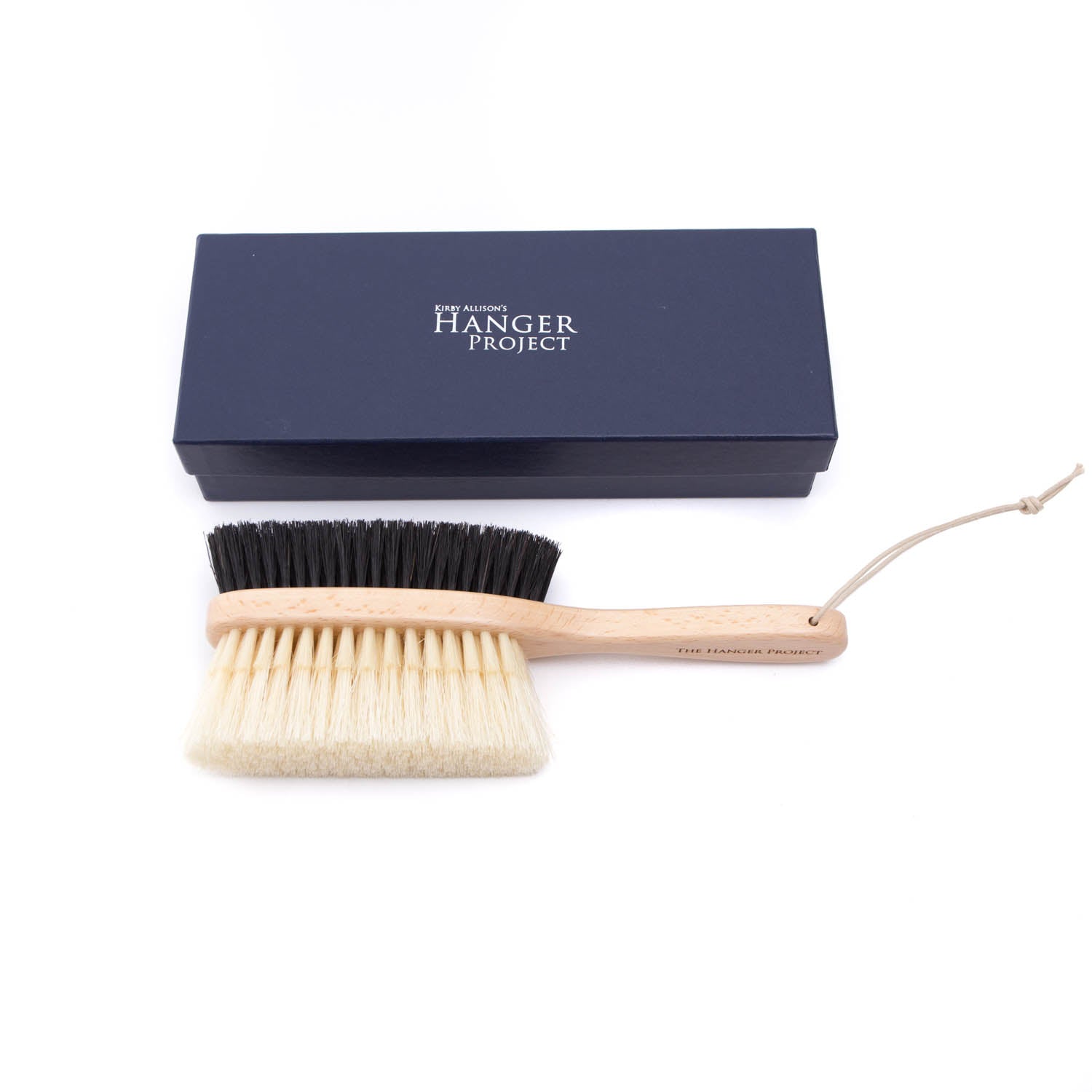 A KirbyAllison.com Deluxe Double-Sided Garment Brush with a blue box and a wooden handle.