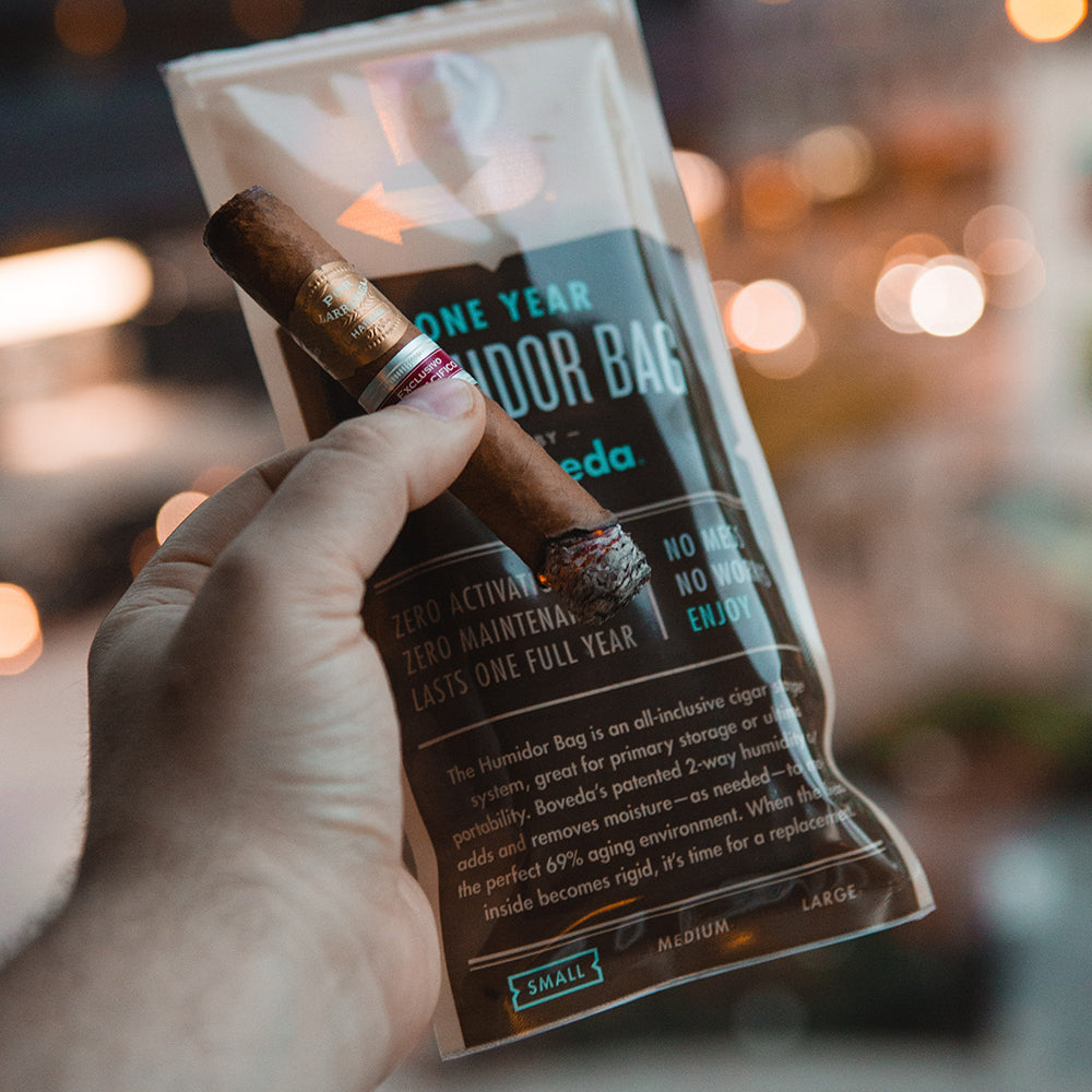 A person storing a cigar in a Boveda Humidor Bag – Small by KirbyAllison.com for humidity bleed.