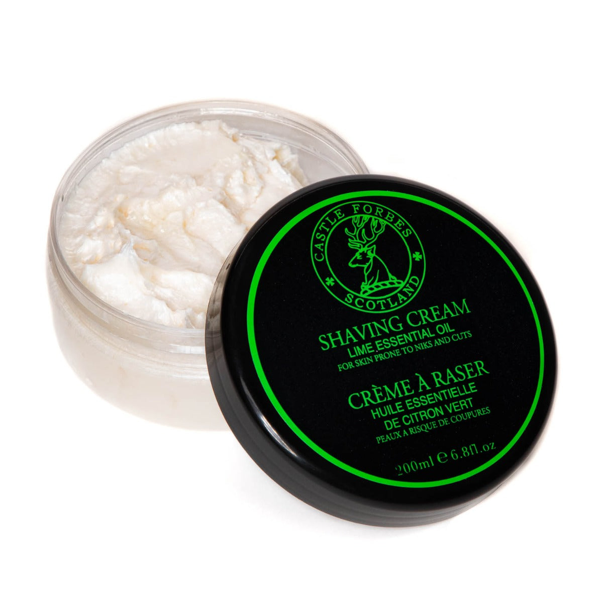 A tin of Castle Forbes Lime Essential Oil Shaving Cream from KirbyAllison.com with lather on a white surface.