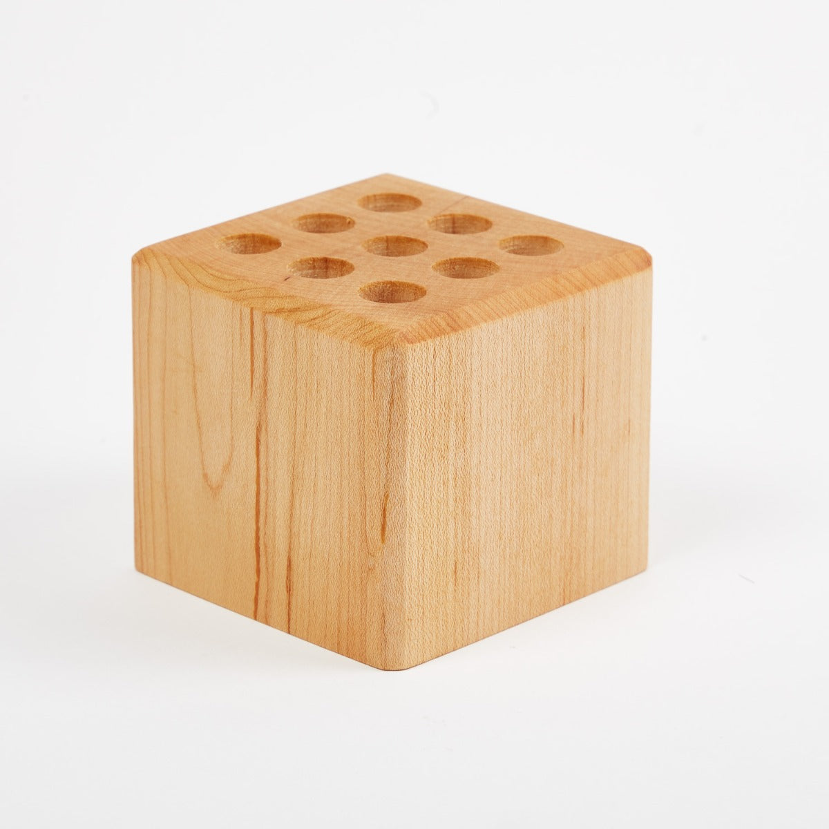A premium wooden cube with holes in it, perfect as a Hanger Project Large Collar Stay Holder from KirbyAllison.com.
