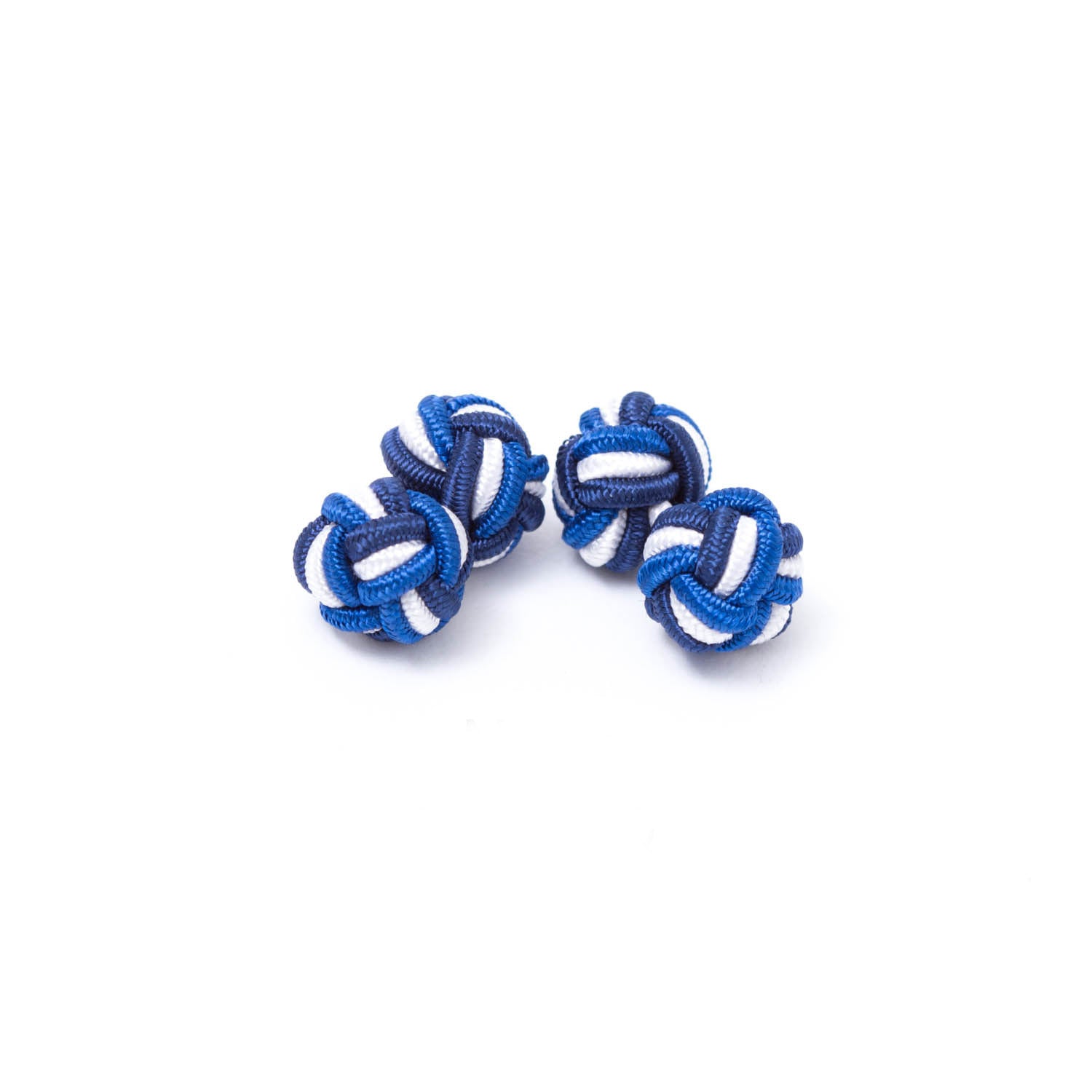 Three Tri-Colored Knot Cufflinks from KirbyAllison.com on a white surface.