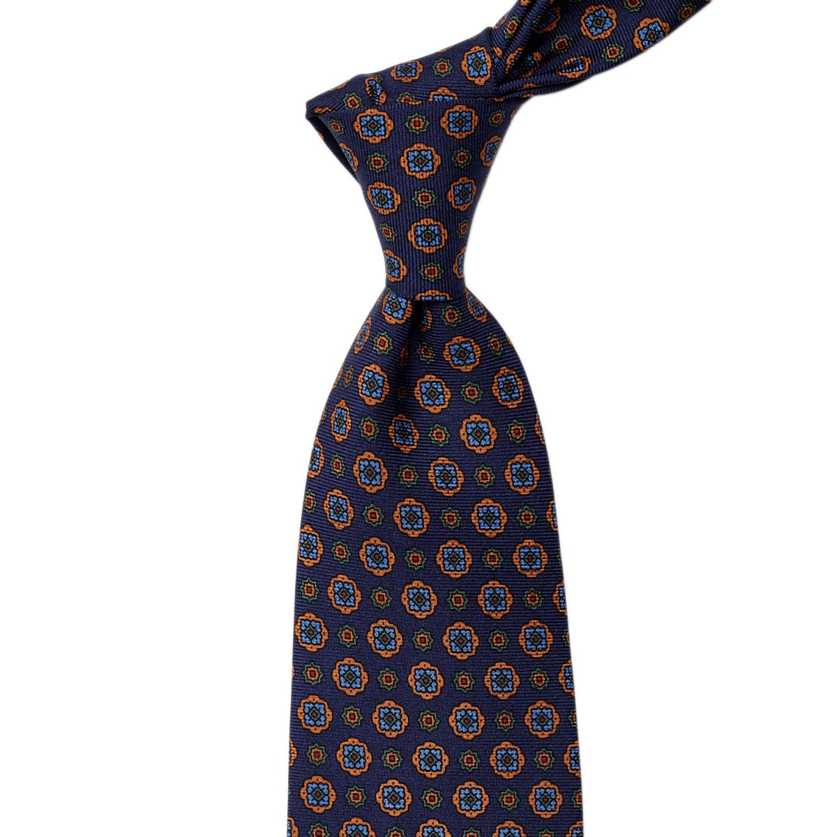 Handmade in the United Kingdom with quality craftsmanship, this KirbyAllison.com Sovereign Grade Navy Geometric Floral 36oz Printed Silk tie features an orange and blue pattern.