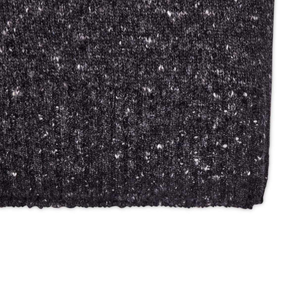 A close up of a black KirbyAllison.com Drumohr knitted beanie.
