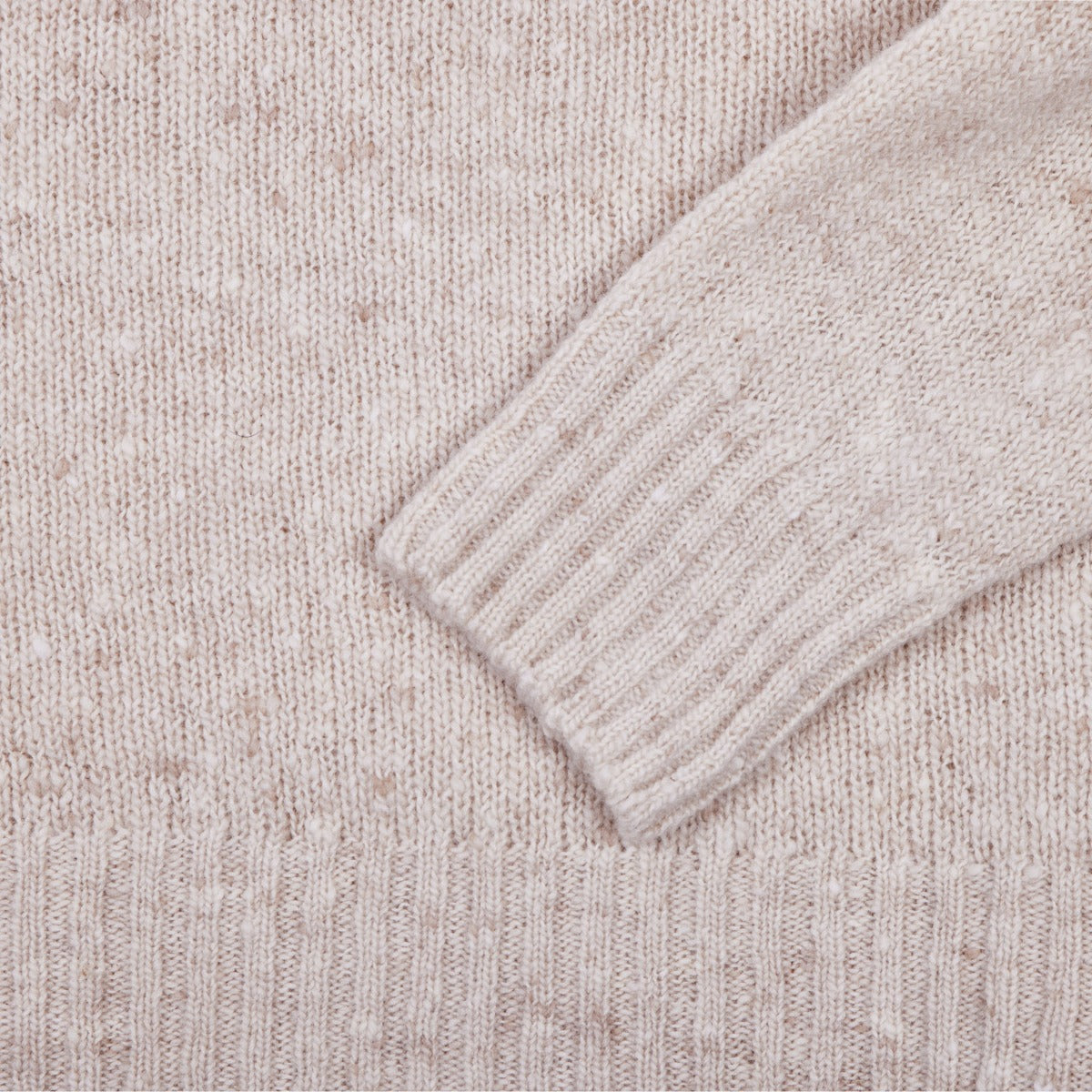 A close up image of a Sovereign Grade Oatmeal Donegal Crew Neck Sweater by KirbyAllison.com.