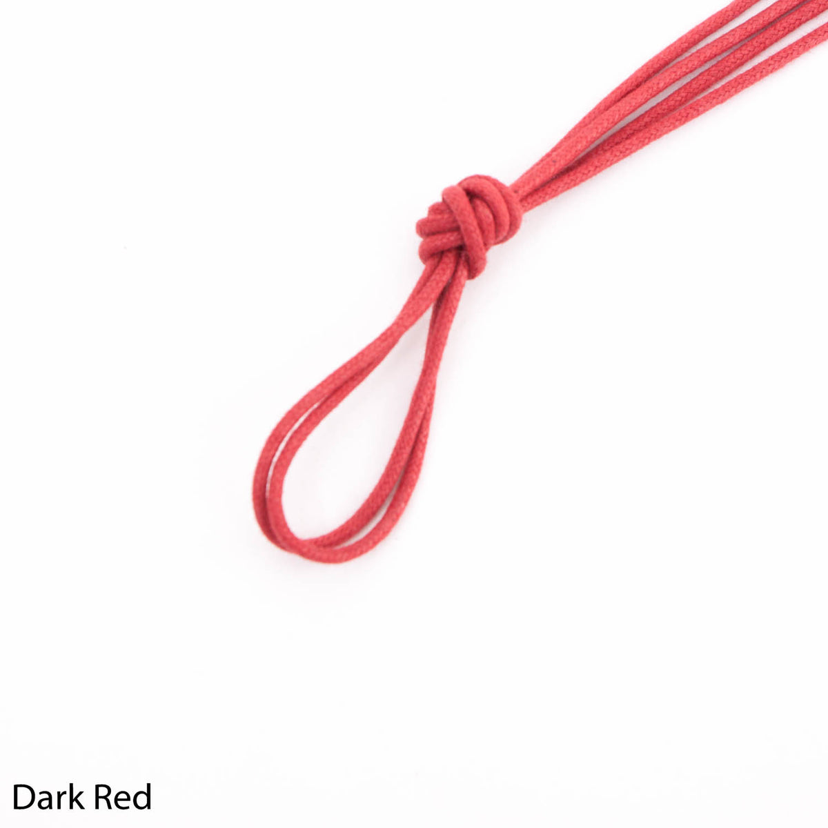 A Wellington Crimson Round Waxed Shoelace 80 cm with a knot on it, from KirbyAllison.com.