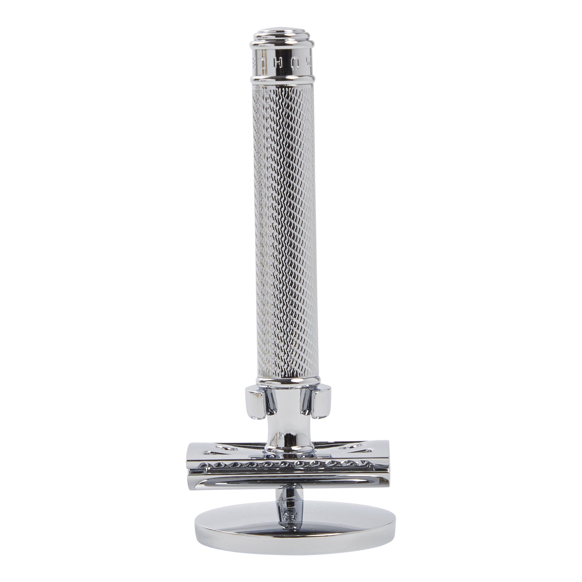 A Muhle Safety Razor Stand by KirbyAllison.com on an elegant man's bathroom countertop.