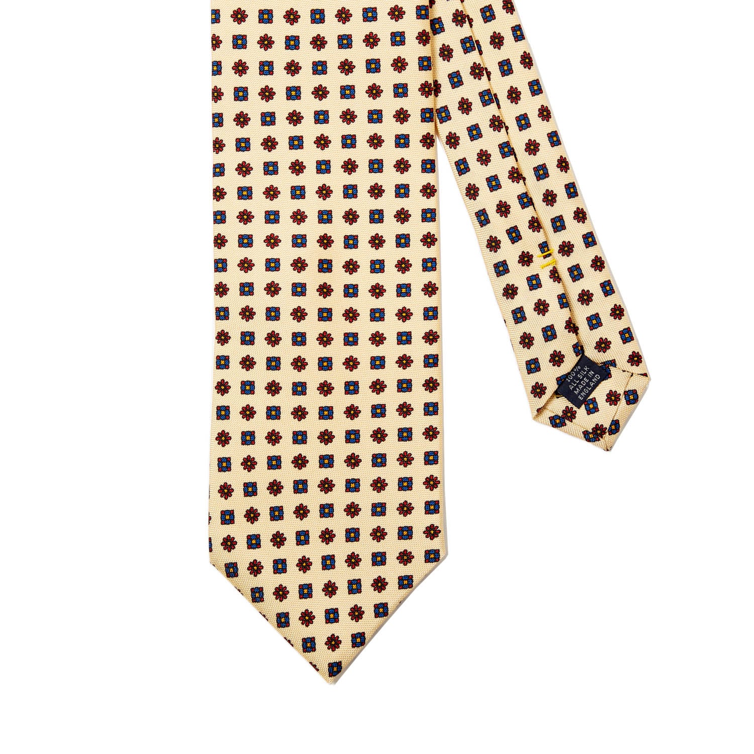 A Sovereign Grade Cream Floral 25oz Silk Hopsack Tie (150x8.5 cm) from KirbyAllison.com, with polka dots on a white background, showcasing craftsmanship from the United Kingdom.