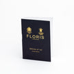 A black book with the logo of KirbyAllison.com on it, filled with FLORIS Special 127 fragrance samples.
