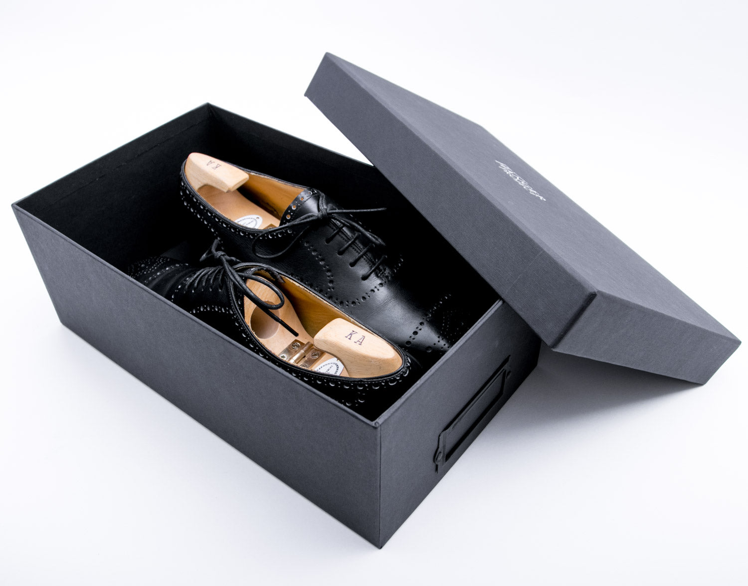 A pair of black Deluxe Wellington Shoe Storage Box shoes by KirbyAllison.com.