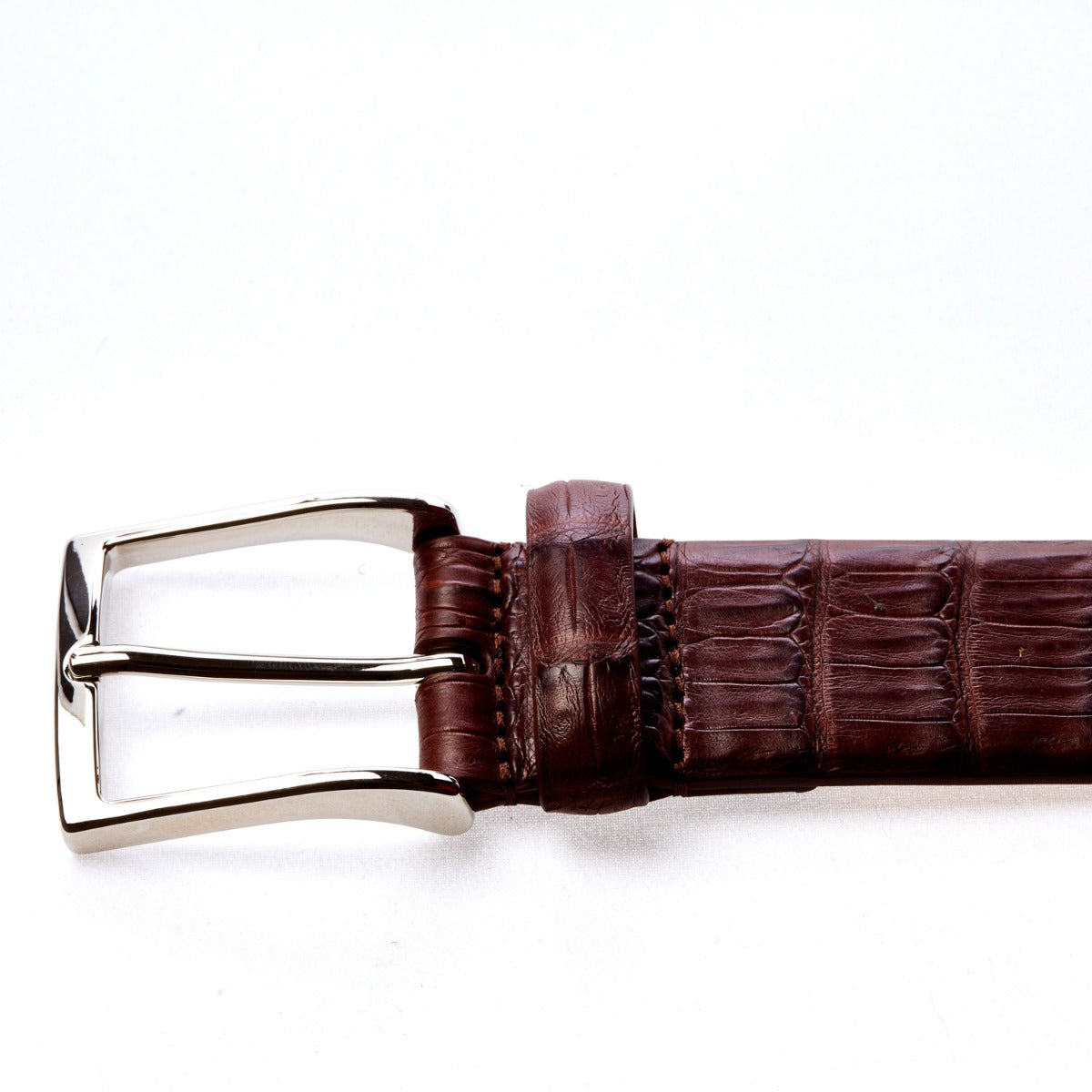 Handcrafted in Italy, a Sovereign Grade Cognac Crocodile Belt with a satin finish on a white background by KirbyAllison.com.
