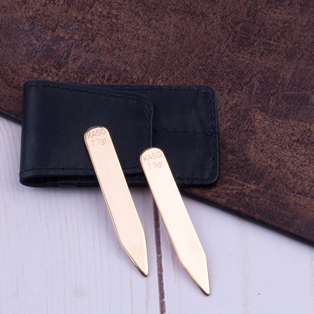 A pair of Sovereign Grade Solid Gold Collar Stays (14k) on a leather wallet from KirbyAllison.com.