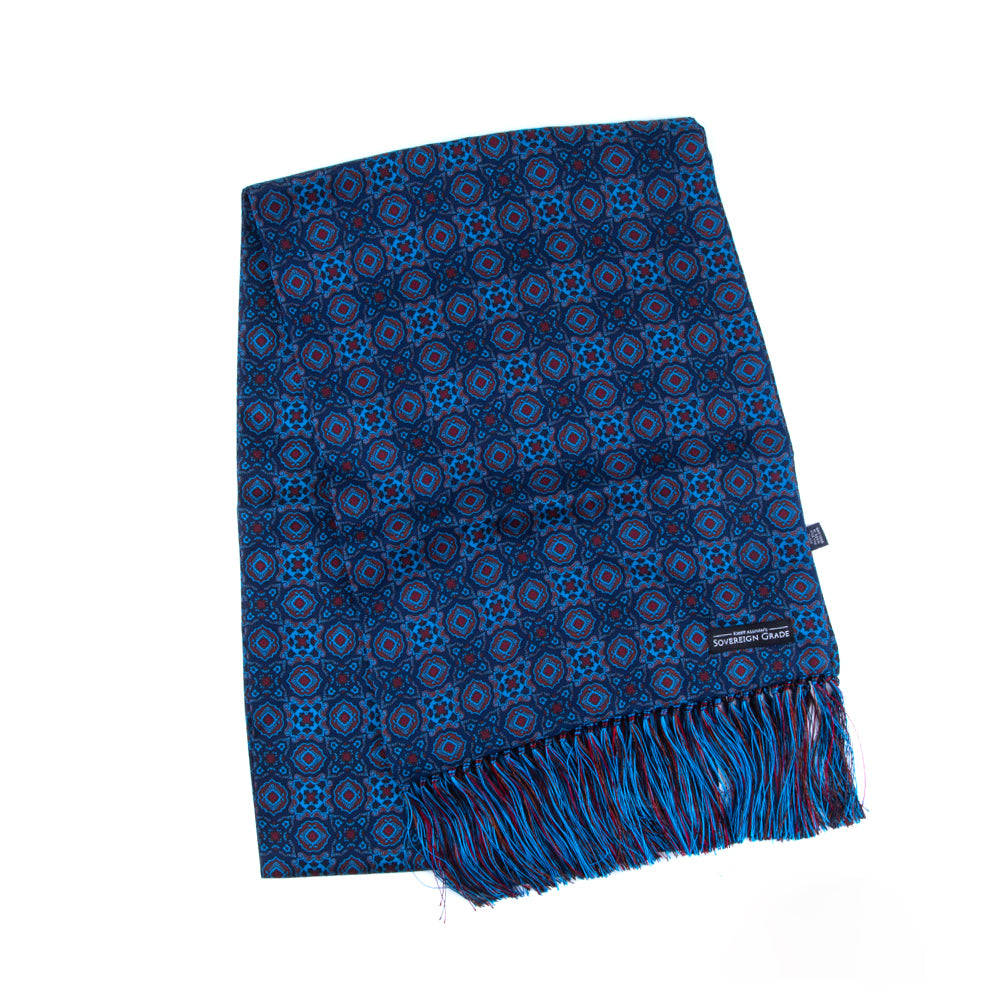 A Sovereign Grade Ancient Madder Blue Motif Silk Scarf by KirbyAllison.com adorned with fringes.