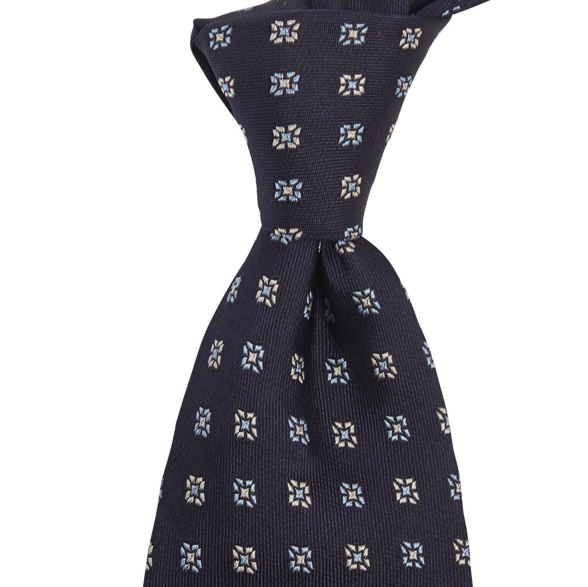 A handmade KirbyAllison.com Sovereign Grade Midnight Blue Square Floral Jacquard Tie with blue flowers on it.