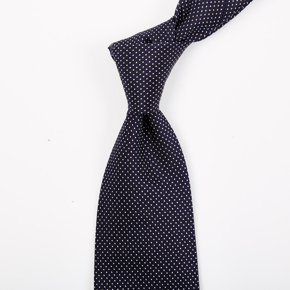 A quality handmade Sovereign Grade Navy Silk Micro Dot tie on a white background by KirbyAllison.com.