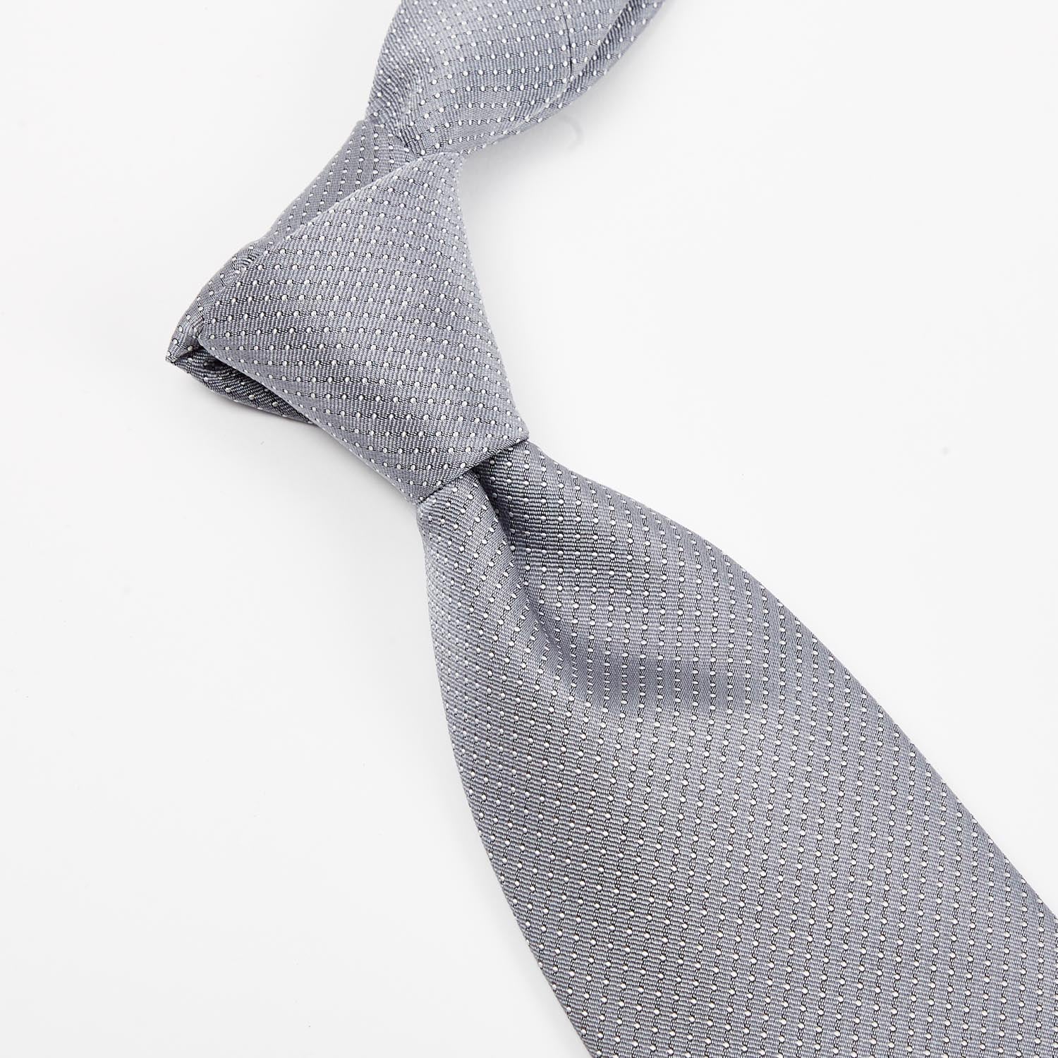 A quality Sovereign Grade Silver Silk Micro Dot Tie from KirbyAllison.com, handmade gray tie on a white background.