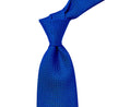 A handmade Sovereign Grade Bright Blue Grenadine Grossa Tie from KirbyAllison.com, showcasing longevity and quality on a white background.