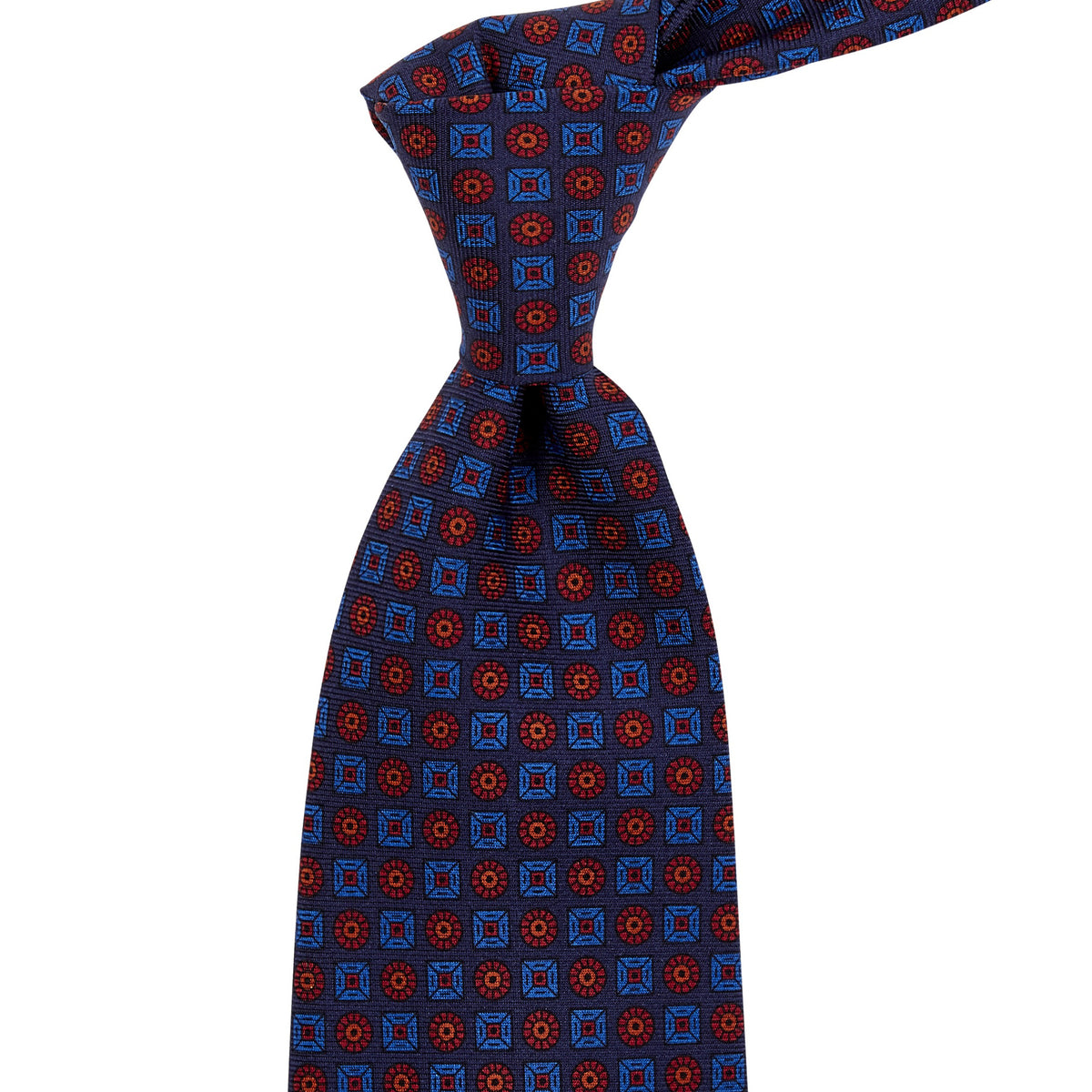 A Sovereign Grade Navy Ancient Madder Tie from KirbyAllison.com handmade in the United Kingdom with a blue and red pattern.