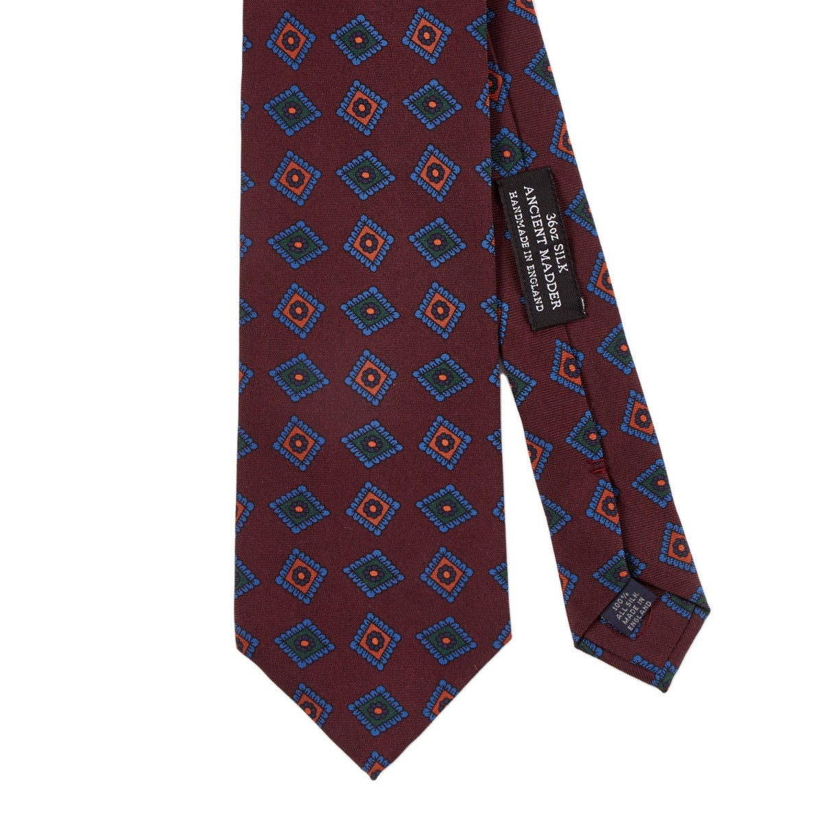 A high-quality handmade Sovereign Grade Burgundy Art Deco Ancient Madder Silk Tie with a blue and red pattern, made in the United Kingdom, available at KirbyAllison.com.