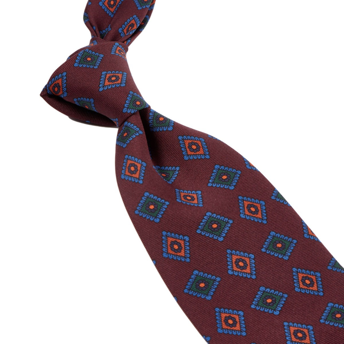 A Sovereign Grade Burgundy Art Deco Ancient Madder Silk Tie with blue and orange designs from KirbyAllison.com.