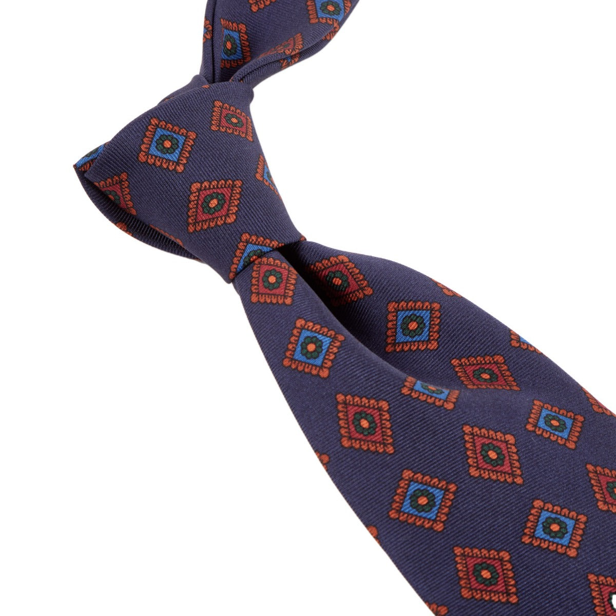 A handmade necktie with an orange and blue pattern from KirbyAllison.com's Sovereign Grade Dark Navy Art Deco Ancient Madder Silk Tie.