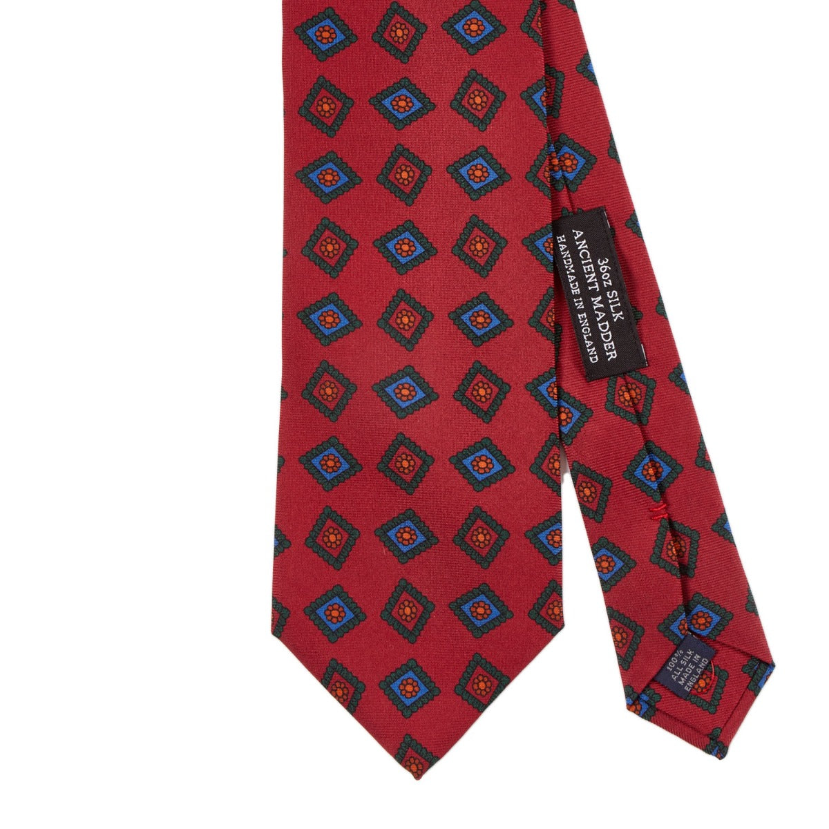 A Sovereign Grade Rust Art Deco Ancient Madder Silk Tie by KirbyAllison.com, with a blue and red pattern.