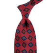 A Sovereign Grade Rust Art Deco Ancient Madder Silk Tie from KirbyAllison.com, with a blue and red pattern, made in the United Kingdom.