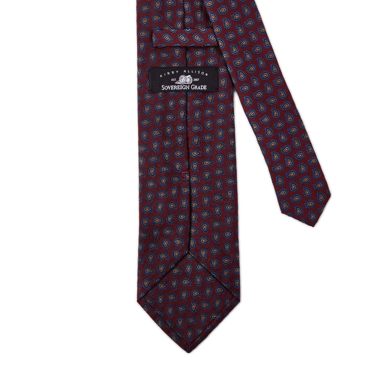 A high-quality handmade Sovereign Grade Burgundy Paisley Jacquard Silk Tie with blue and red polka dots, made in the United Kingdom by KirbyAllison.com.