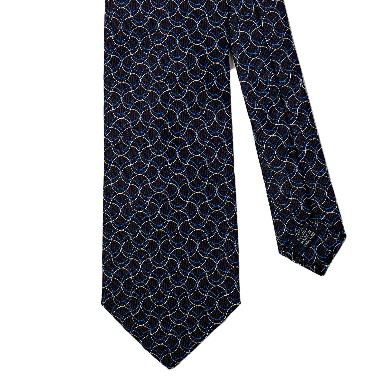 A KirbyAllison.com handmade Sovereign Grade Navy Swirl Jacquard Tie with a geometric pattern on it, from the United Kingdom.