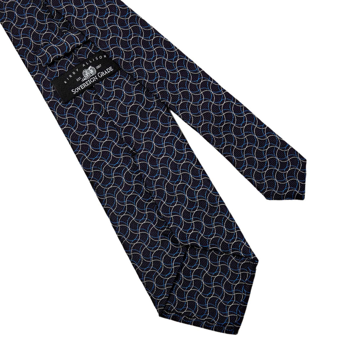 A Sovereign Grade Navy Swirl Jacquard Tie from KirbyAllison.com, handmade with a blue and black geometric pattern, from the United Kingdom.