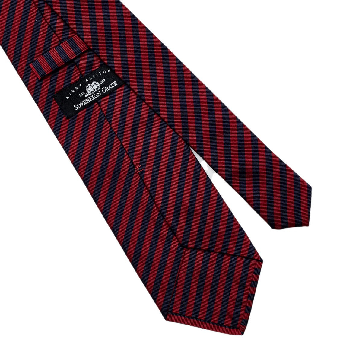 A Sovereign Grade Navy and Red London Stripe Silk Tie of quality craftsmanship on a white background from KirbyAllison.com.