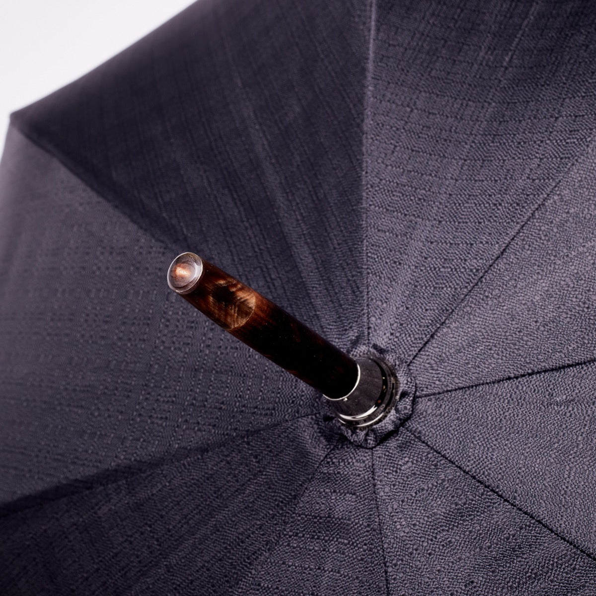 A close up of a Shiny Tiger Maple Handle umbrella with an Imperial Black Canopy, made from Tiger Maplewood by KirbyAllison.com.
