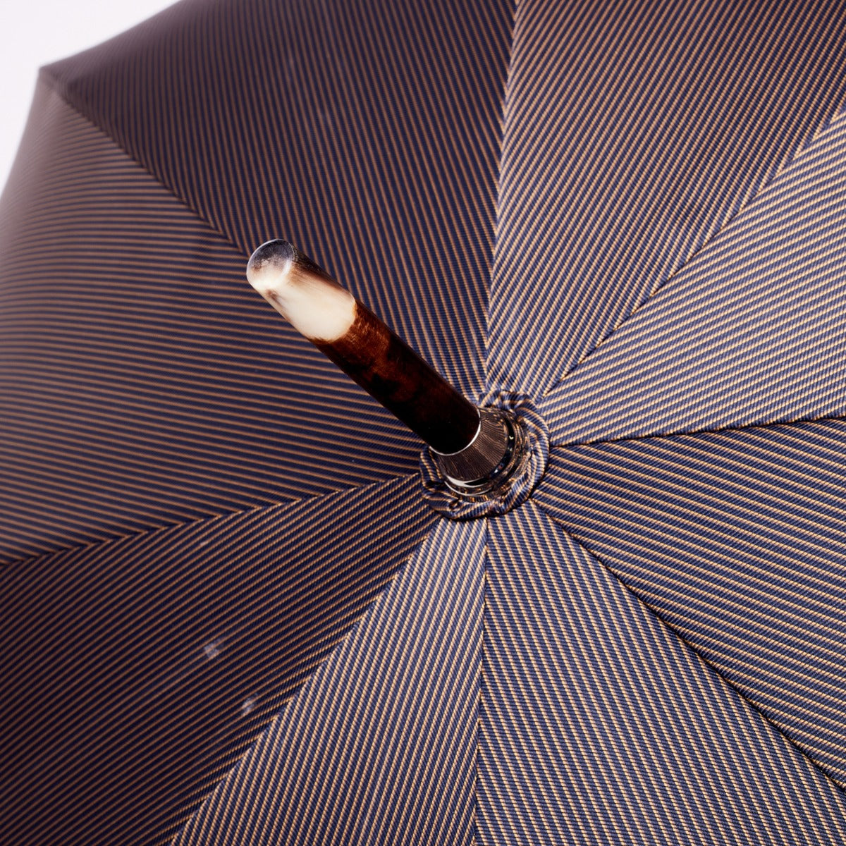A Shiny Tiger Maplewood Handle w/Navy Pinstripe KirbyAllison.com solid-stick umbrella.