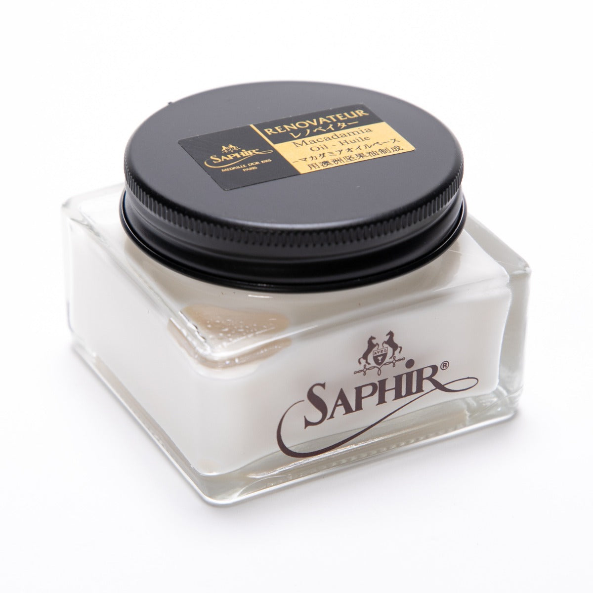 A white jar with a gold lid on a white surface, containing Saphir Renovateur w/ Macadamia Oil from KirbyAllison.com.