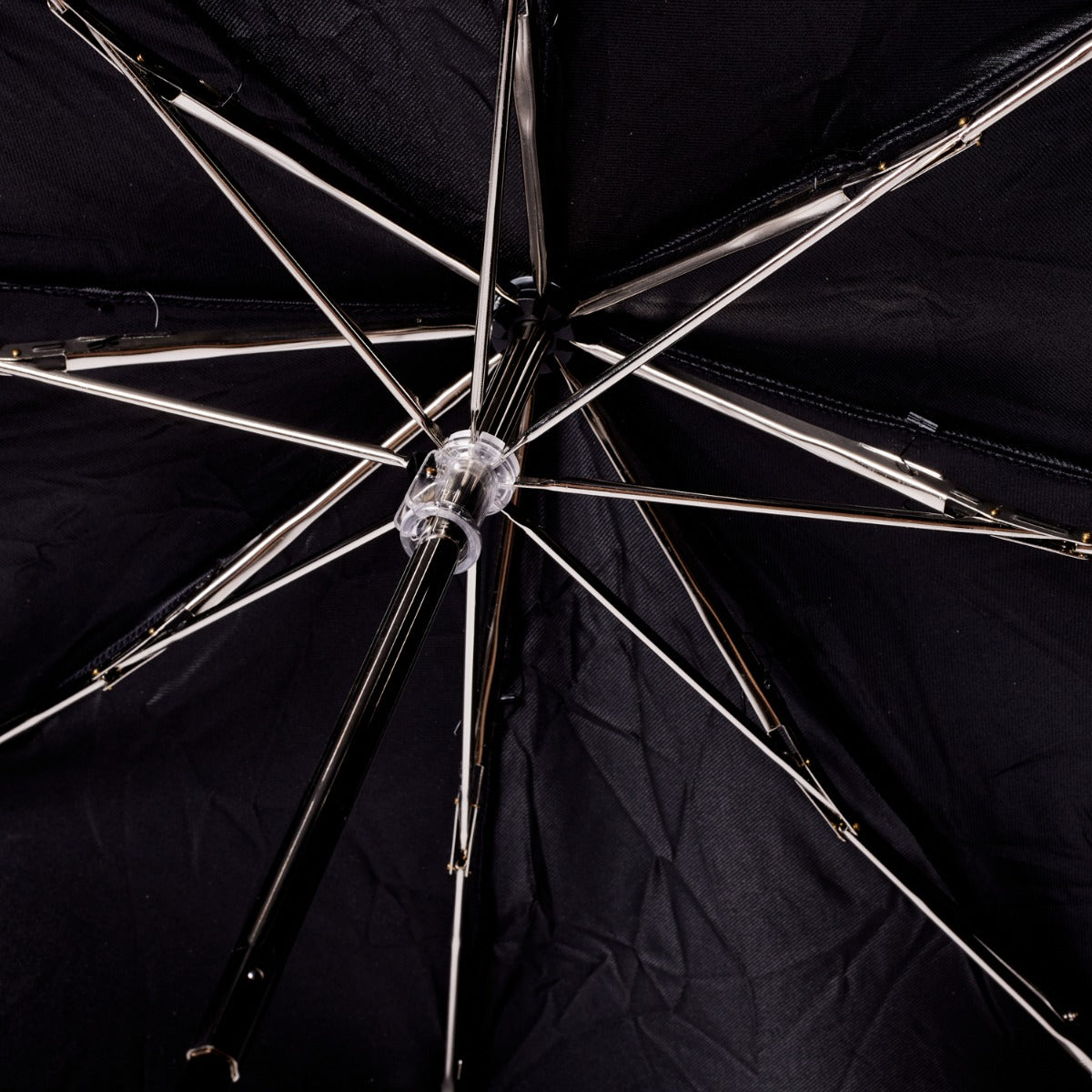 A Brown Alligator Travel Umbrella with Black Canopy by KirbyAllison.com, featuring a handcrafted design and a metal handle.