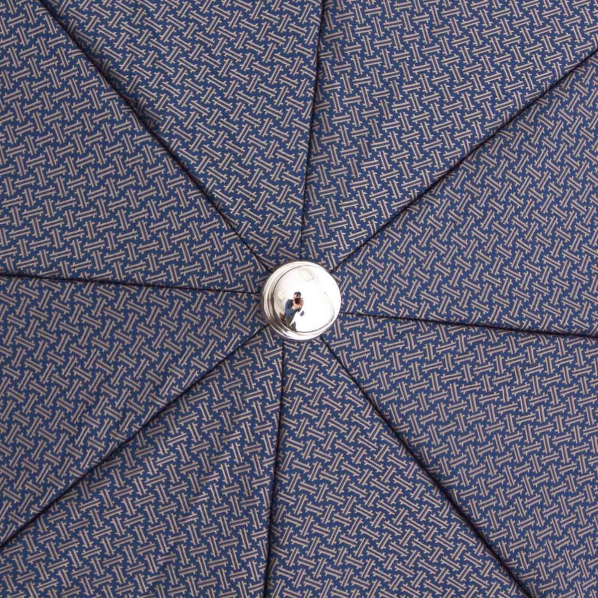 A close up of a Patterned Navy Travel Umbrella with Leather Handle from KirbyAllison.com.