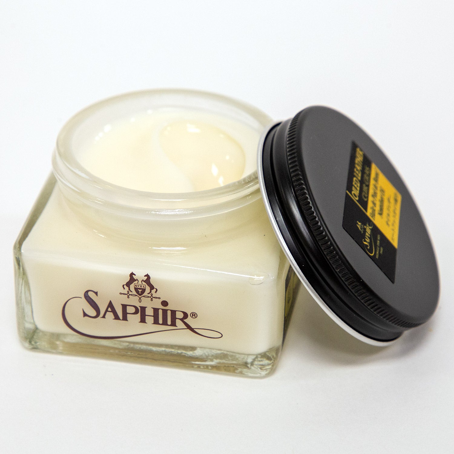 A jar of Saphir Medaille d'Or Oiled Leather Cream for Chromexcel is beautifully displayed on a white surface by KirbyAllison.com.