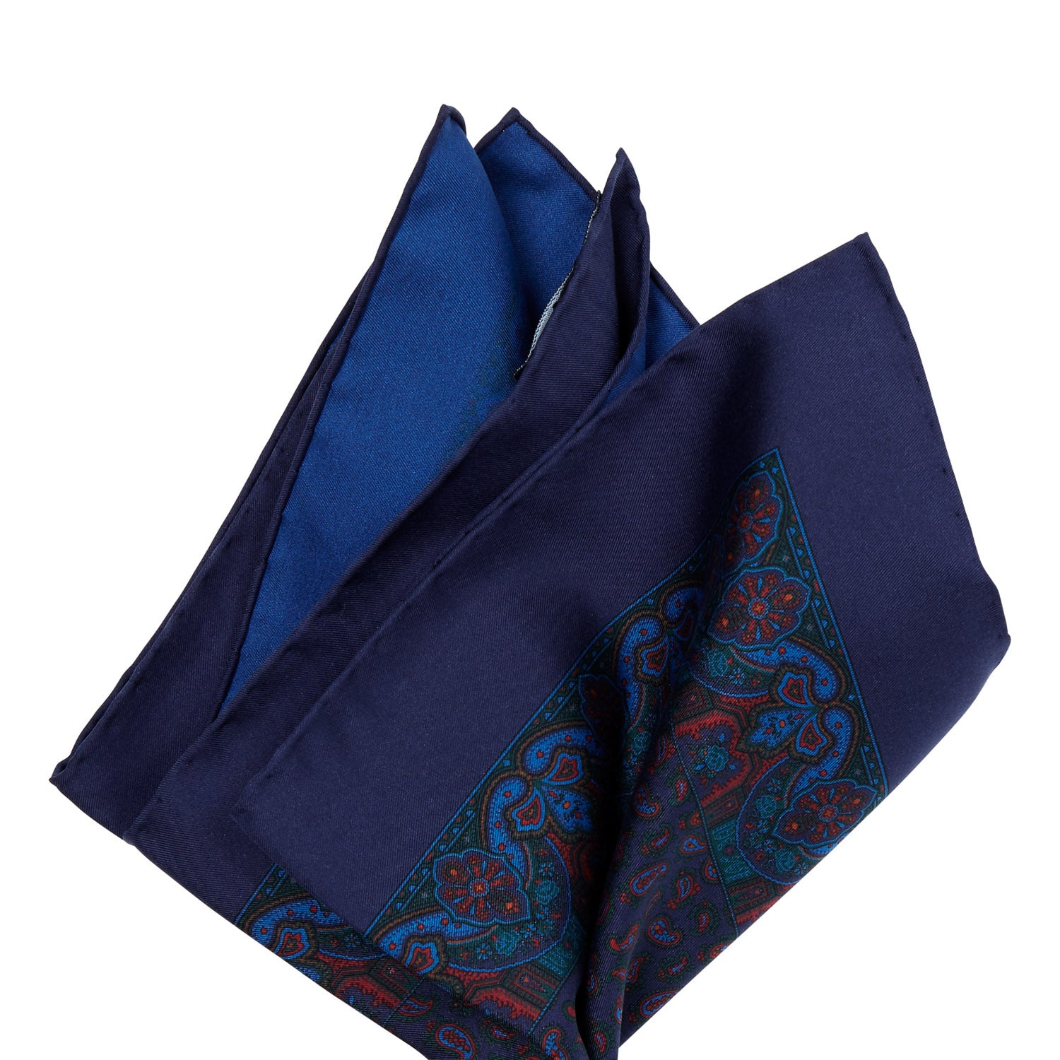 A Sovereign Grade Ancient Madder Midnight Paisley Pocket Square with hand-rolled edges in a blue and red paisley design from KirbyAllison.com.