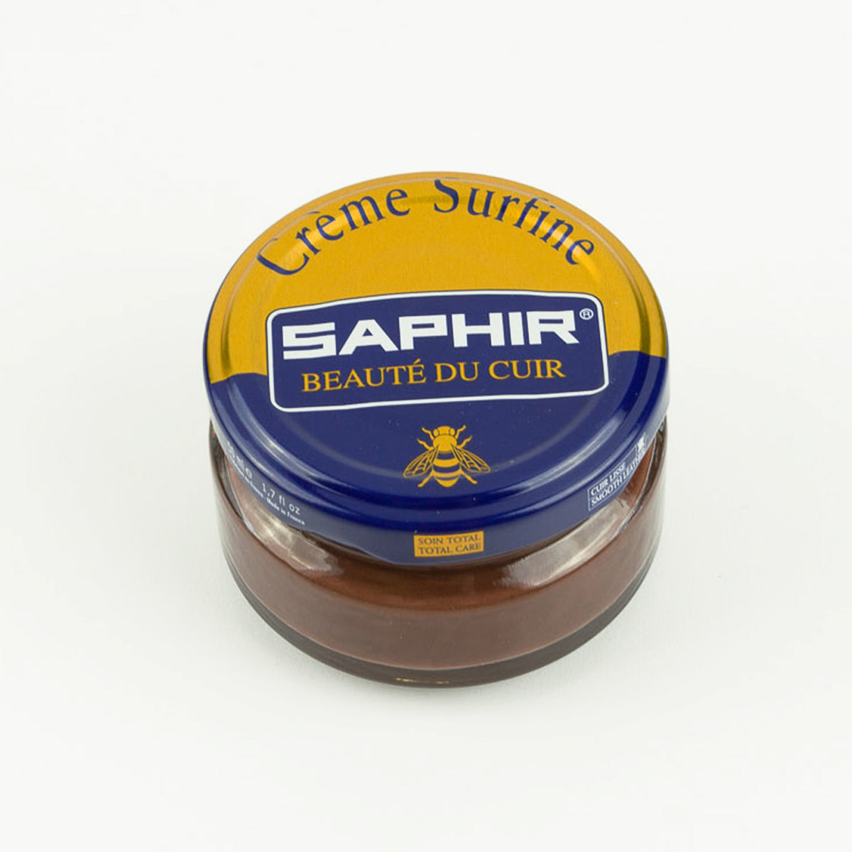 A jar of Saphir Beaute de Cuir Cream Polish surging on a white background, highlighting the keywords "shoe polish" and "beeswax", by KirbyAllison.com.