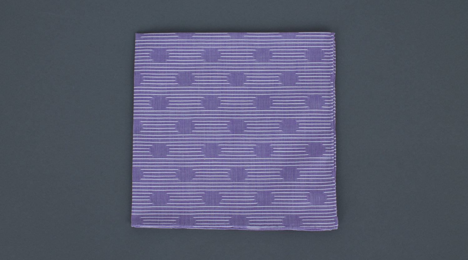 A high quality Simonnot Godard Violet Les Pois Fils Coupe Cotton Pocket Square made of cotton, featuring purple and white stripes on a grey background.