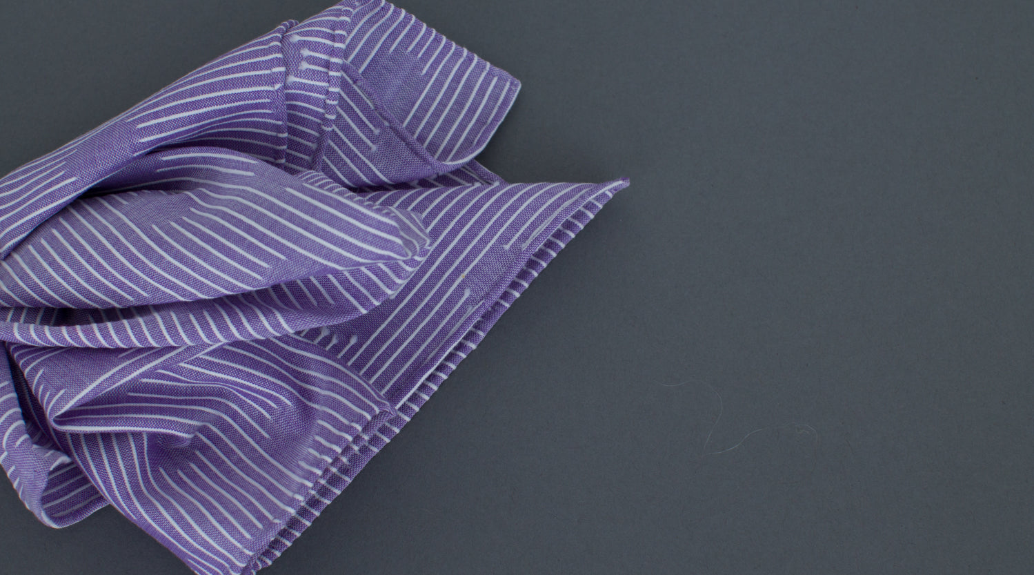 High quality Simonnot Godard Violet Les Pois Fils Coupe Cotton Pocket Square in purple and white stripes, on a grey background, available at KirbyAllison.com.